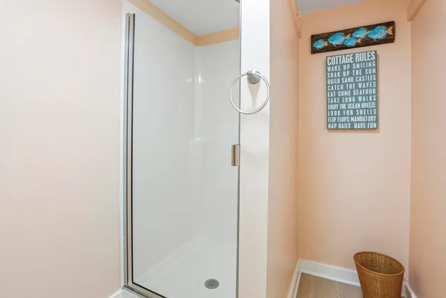 a bathroom with a window and a shower