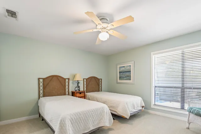 a bedroom with two beds and a window