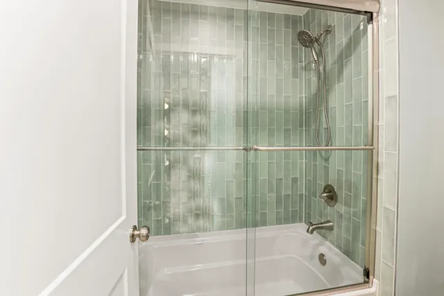 a bathroom with a bathtub and a shower