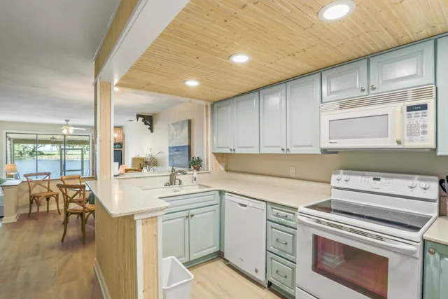 a kitchen with a stove a sink and cabinets
