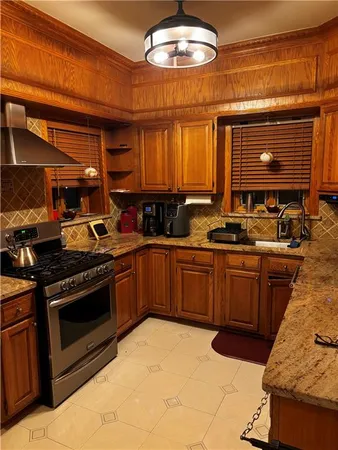 a kitchen with stainless steel appliances a stove a sink and a microwave