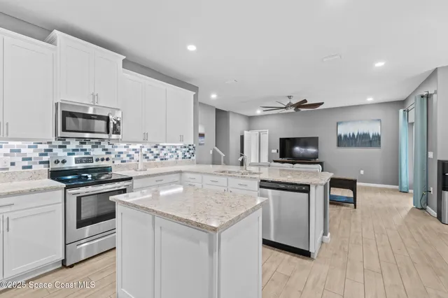 a kitchen with granite countertop a stove and a sink