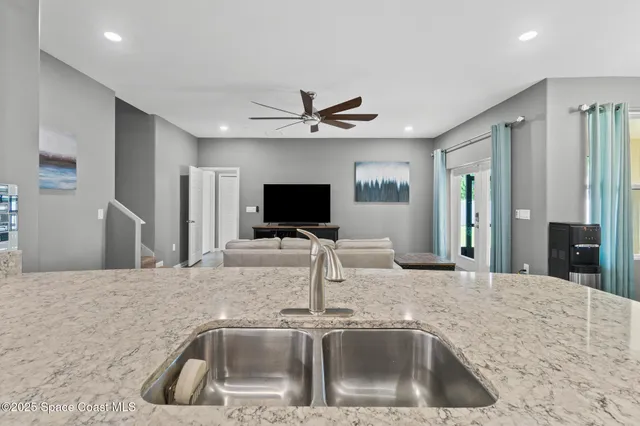 a view of a dining room with furniture and a chandelier