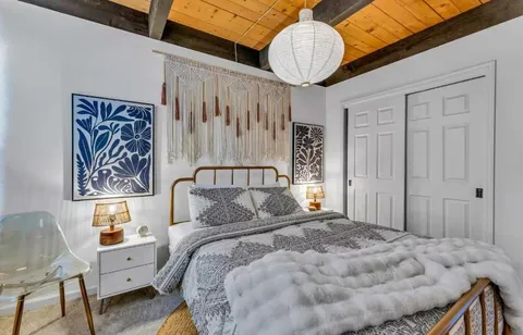 a bedroom with a bed and a chandelier