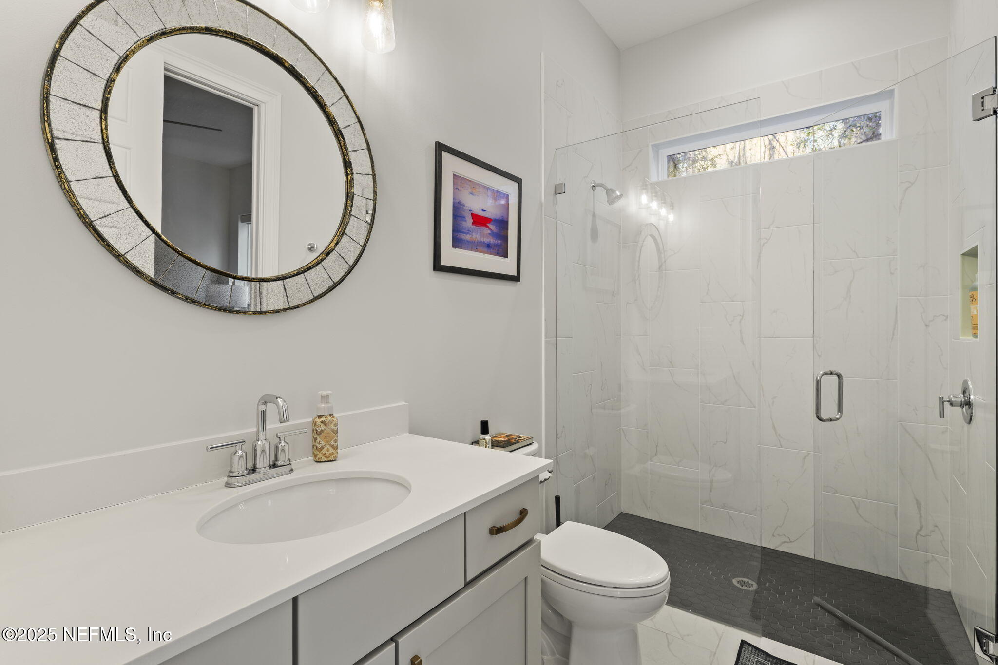 251 Vale Drive St. Augustine, FL 32095 - Photo 40 of 74 a bathroom with a sink a mirror a toilet and a shower