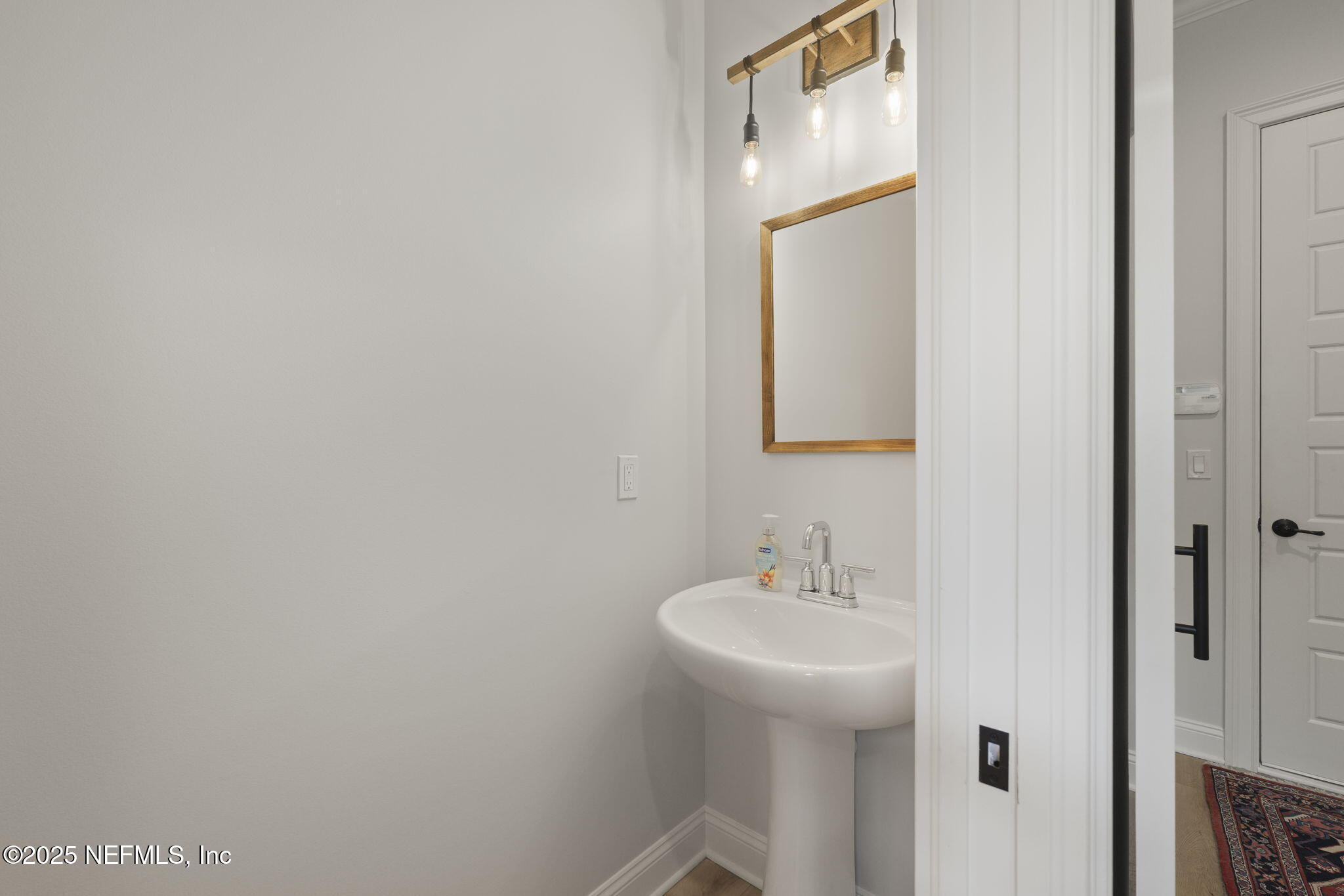 251 Vale Drive St. Augustine, FL 32095 - Photo 44 of 74 a bathroom with a sink and a mirror
