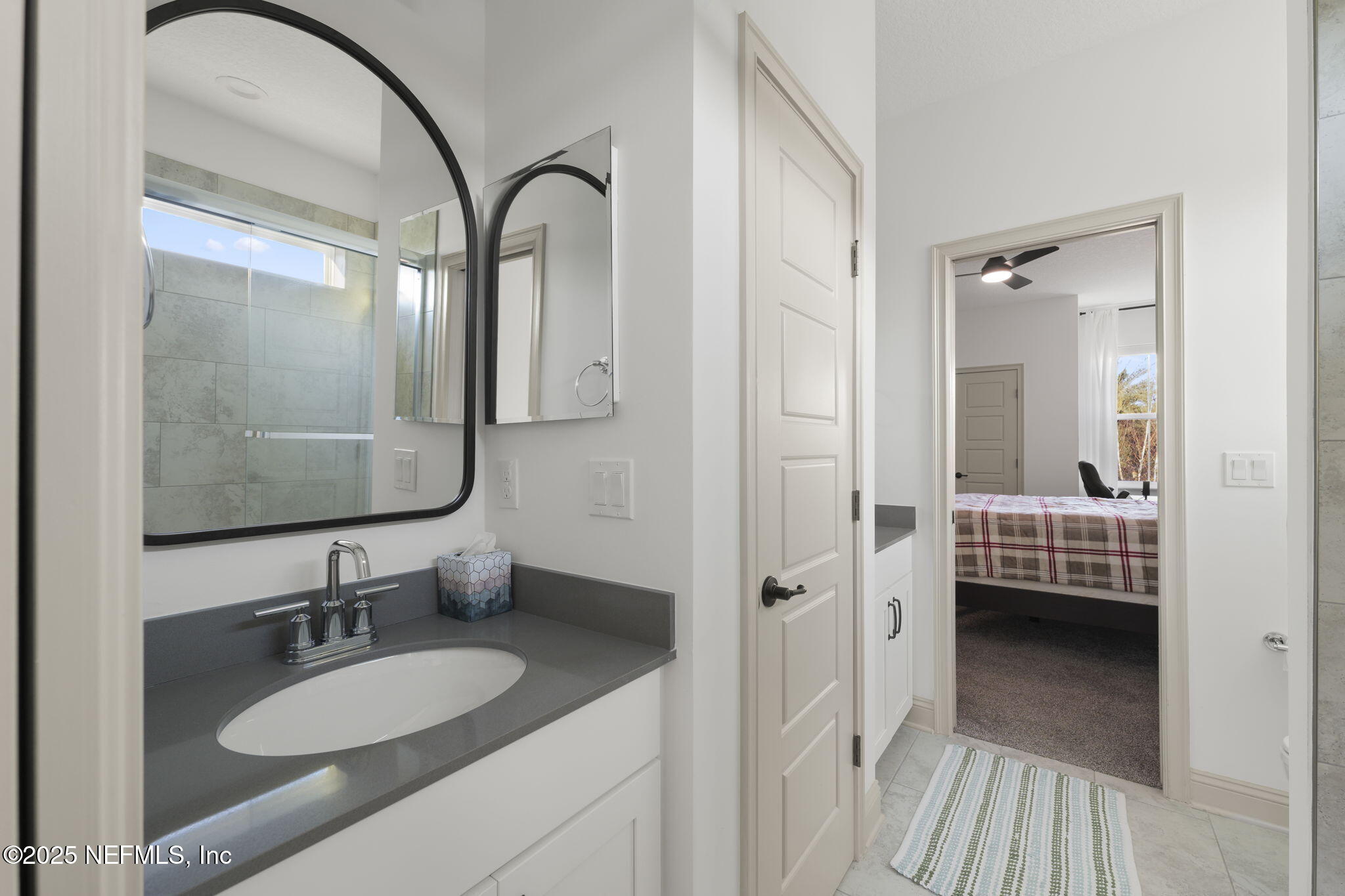 251 Vale Drive St. Augustine, FL 32095 - Photo 70 of 74 a en suite bathroom with a granite countertop sink and a mirror