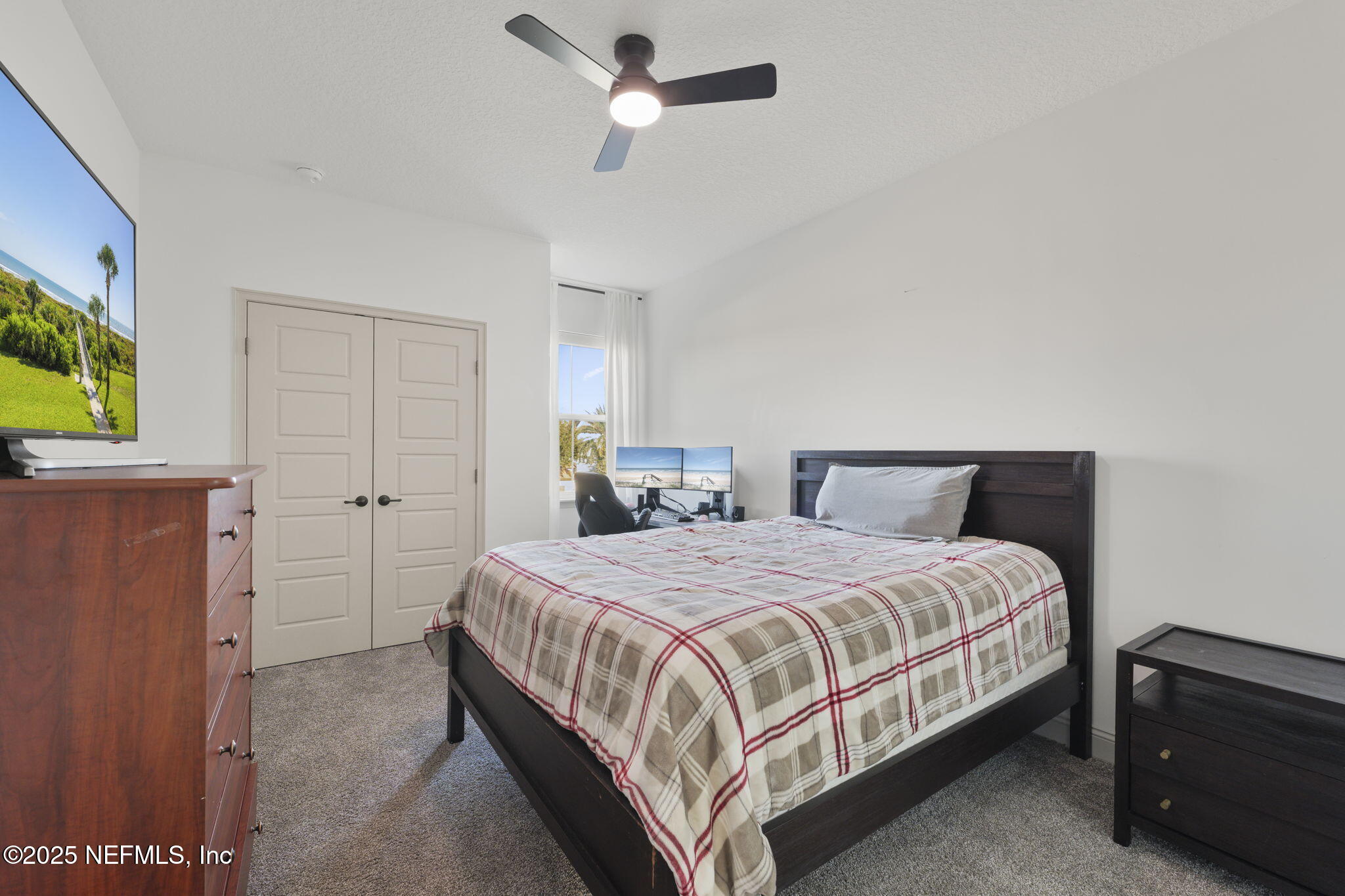 251 Vale Drive St. Augustine, FL 32095 - Photo 73 of 74 a bedroom with a bed and a chandelier