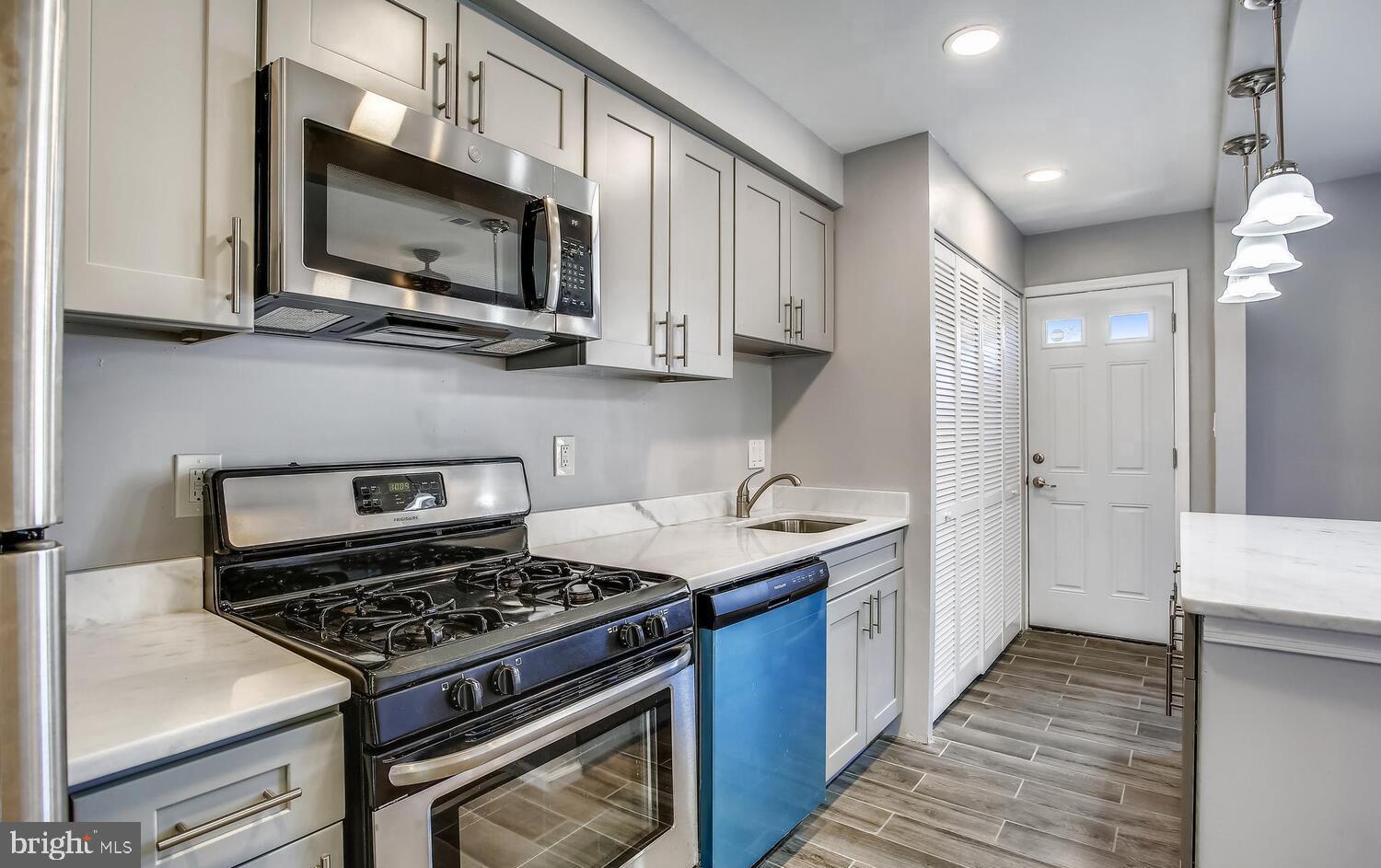 1240 Simms Place Northeast, Unit A Washington, DC 20002 - Photo 2 of 9 a kitchen with stainless steel appliances granite countertop a stove and a microwave
