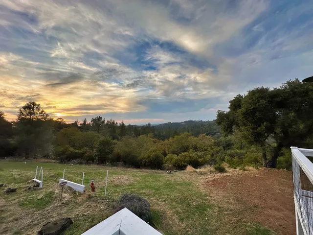 a view of a street with next to a yard