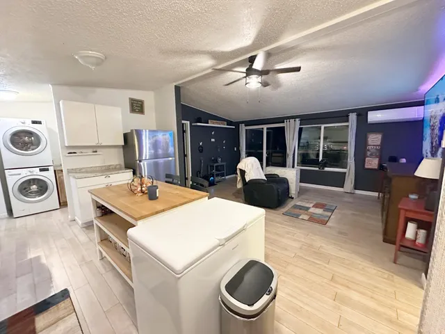 a kitchen with a stove a sink a microwave and cabinets