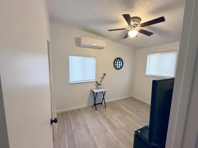 a view of room with wooden floor and workspace