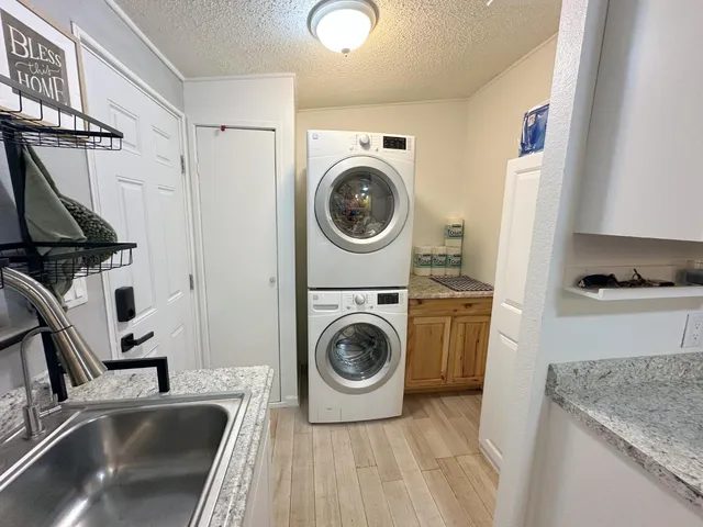 a utility room with sink dryer and washer