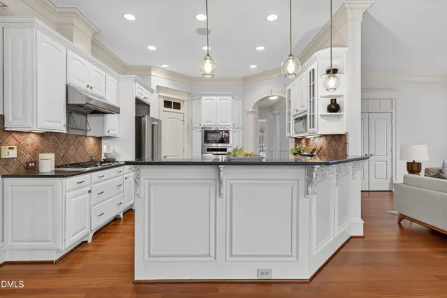 a bathroom with a bathtub shower sink vanity and toilet