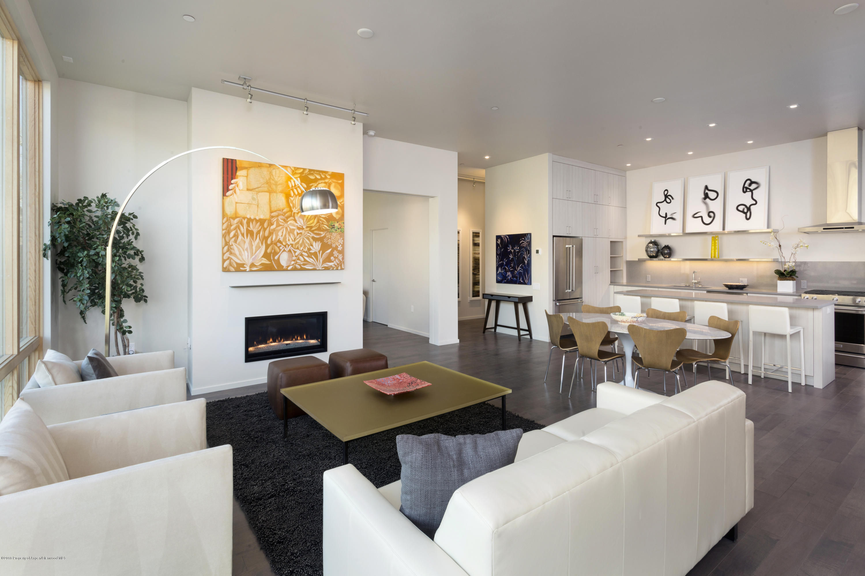 a living room with fireplace furniture and a table