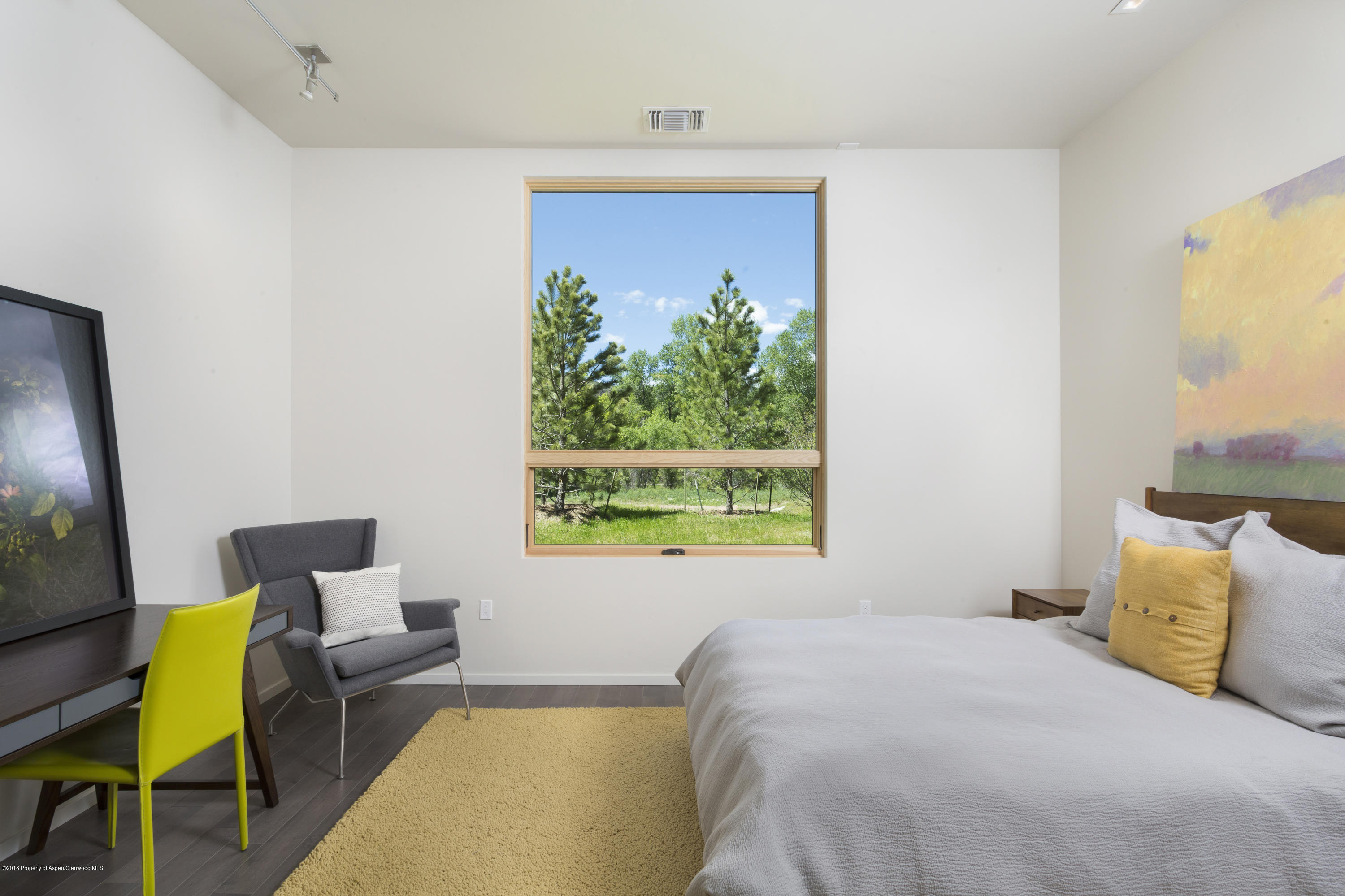 100 Evans Road, Unit 202 Basalt, CO 81621 - Photo 16 of 25 a bedroom with a bed a window and painting on the wall