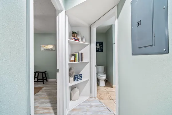 a view of a hallway with bathroom and shower
