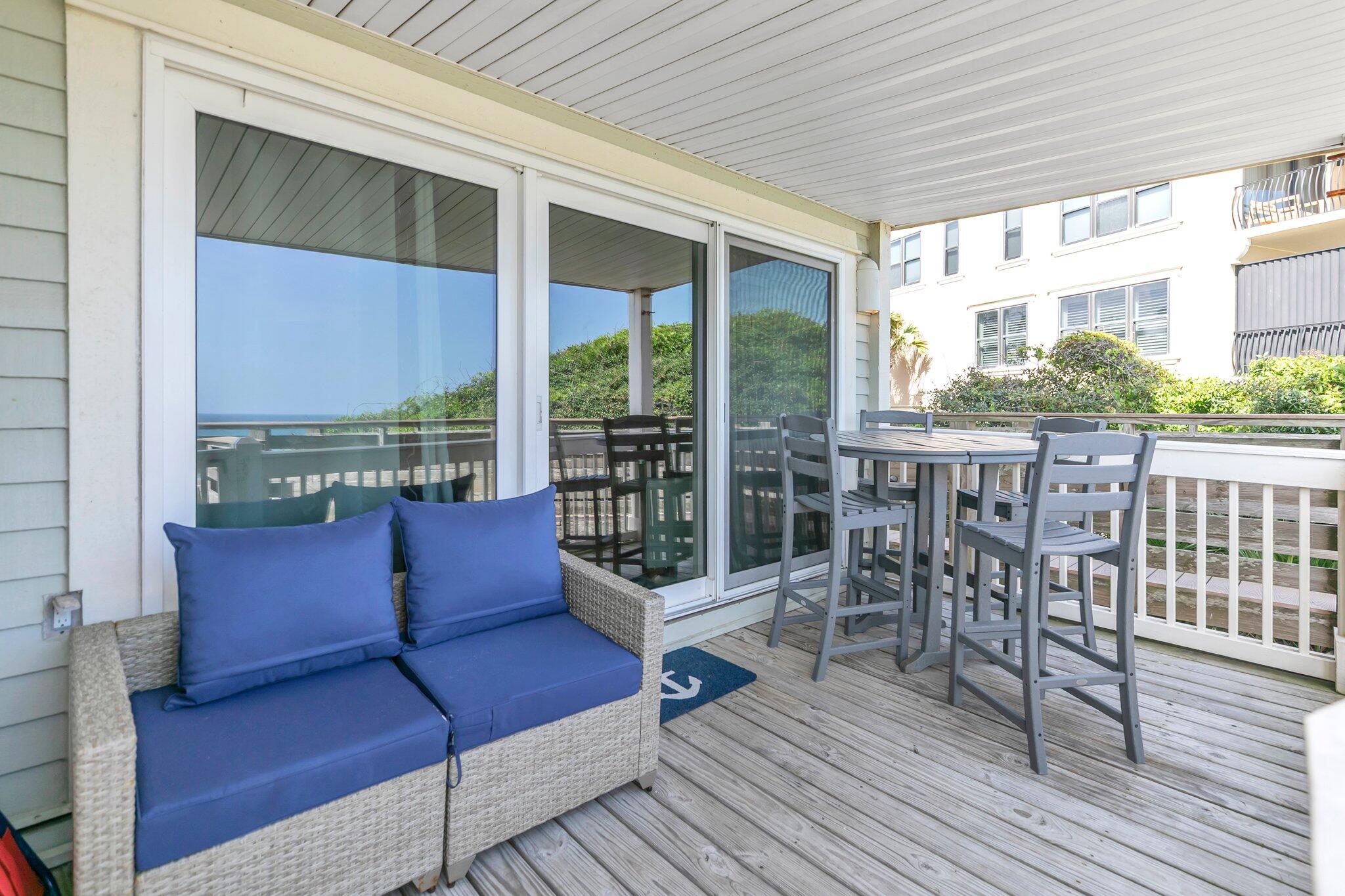 8294 East County Highway 30A, Unit 1 Inlet Beach, FL 32461 - Photo 18 of 45 a roof deck with table and chairs and wooden floor