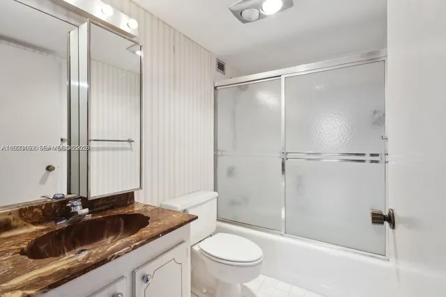 a bathroom with a granite countertop sink mirror and a