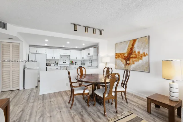 a view of a dining room with furniture and a wooden floor