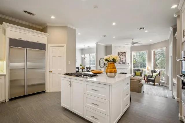 a kitchen with stainless steel appliances granite countertop a sink a stove and a refrigerator
