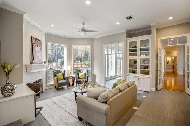 a living room with furniture and large windows