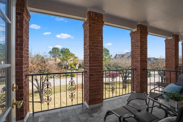 a spacious bedroom with a large bed and a chandelier