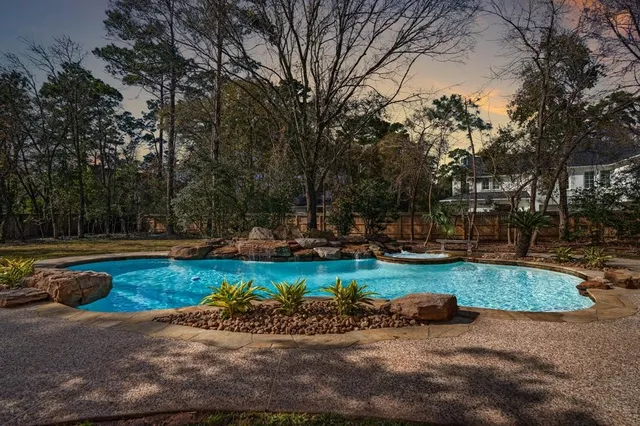 a view of a swimming pool and lounge chairs