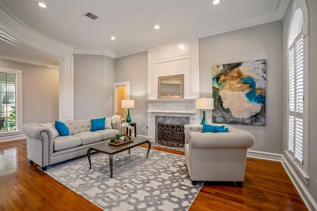 a living room with furniture a fireplace and a window