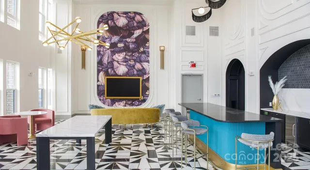 a dining hall with stainless steel appliances wooden floor dining table and chairs