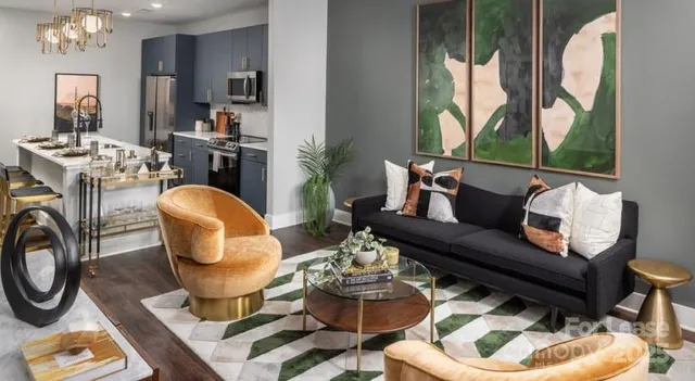 a kitchen with stainless steel appliances kitchen island granite countertop a table and chairs