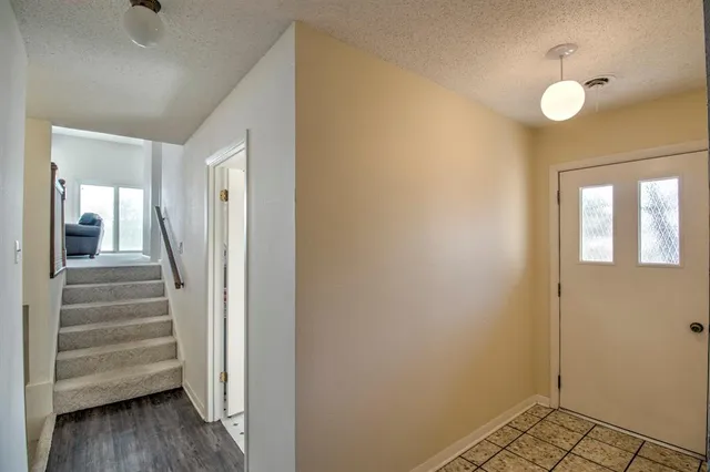 a view of a hallway with wooden floor and entryway