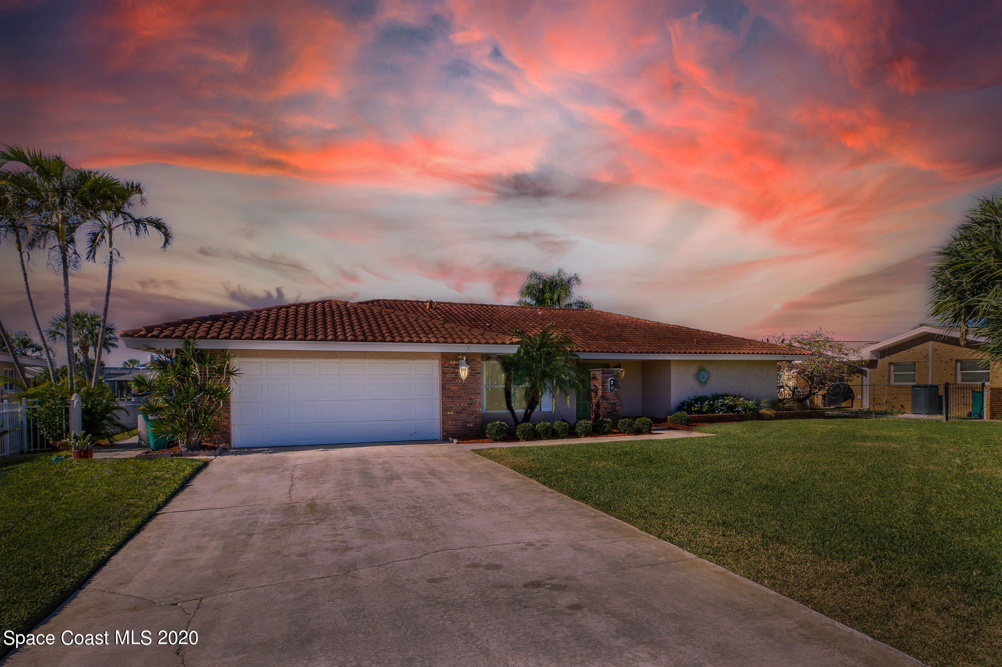 43 Country Club Road Cocoa Beach, FL 32931 - Photo 1 of 35 front view of a house with a yard and palm trees