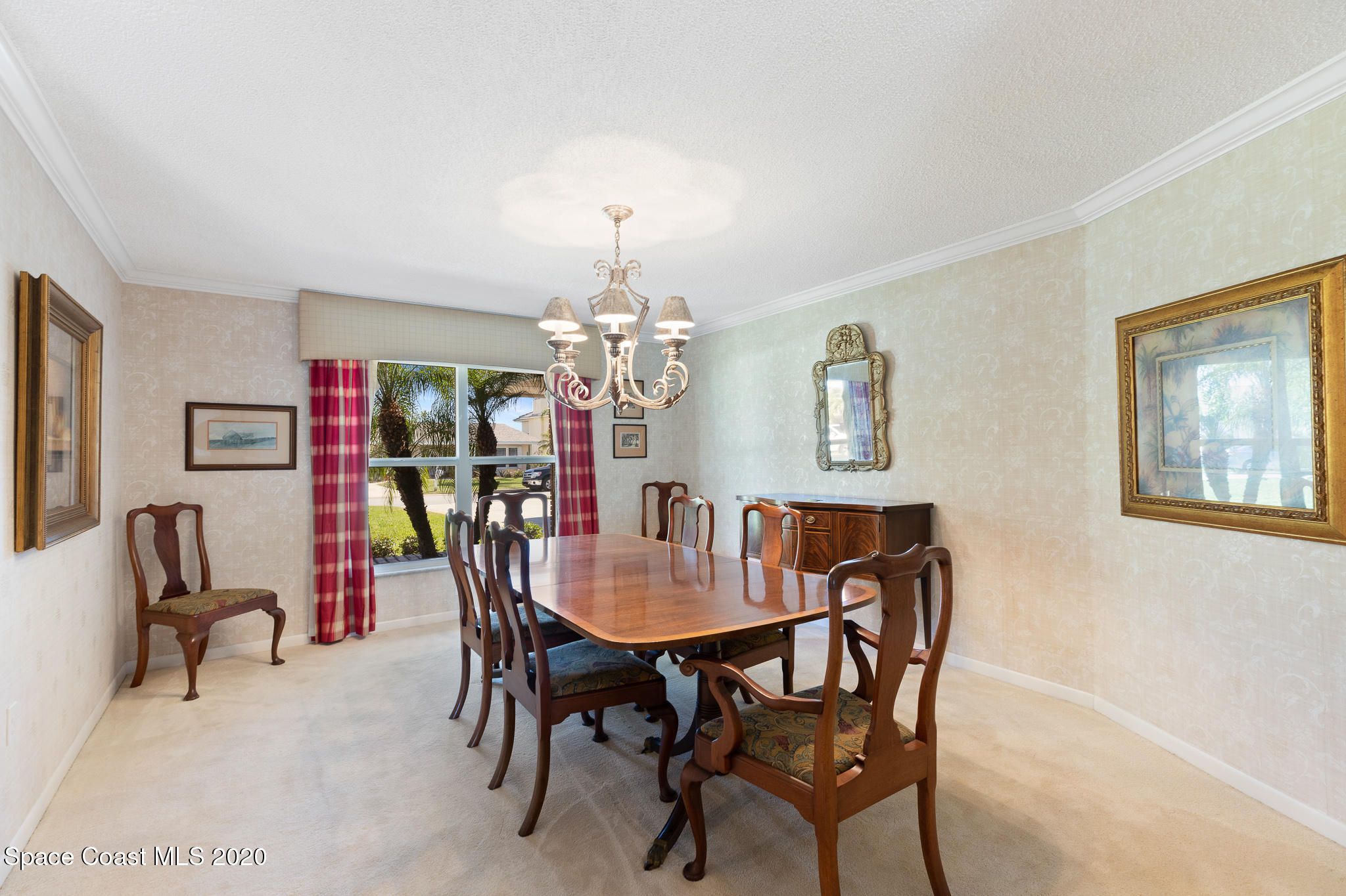 43 Country Club Road Cocoa Beach, FL 32931 - Photo 12 of 35 a view of a dining room with furniture and a chandelier