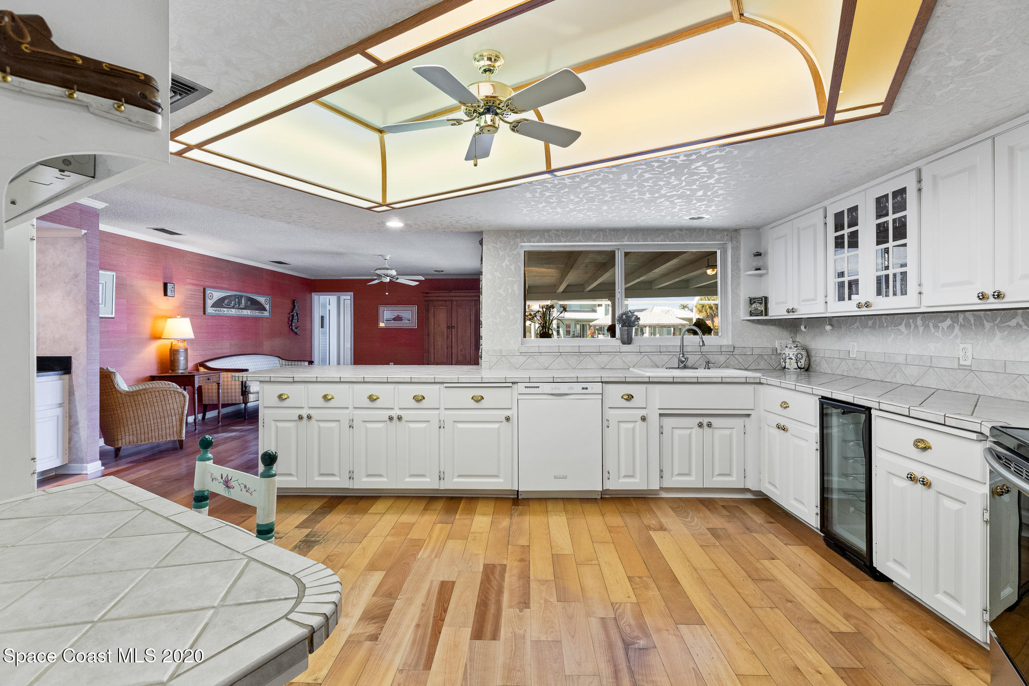 43 Country Club Road Cocoa Beach, FL 32931 - Photo 13 of 35 a kitchen with cabinets a sink and appliances