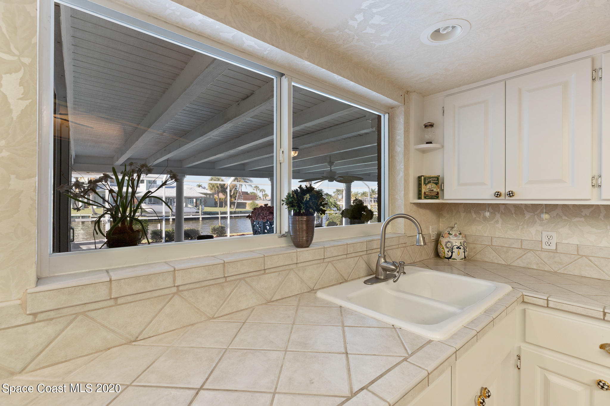 43 Country Club Road Cocoa Beach, FL 32931 - Photo 15 of 35 a kitchen with stainless steel appliances a sink and cabinets