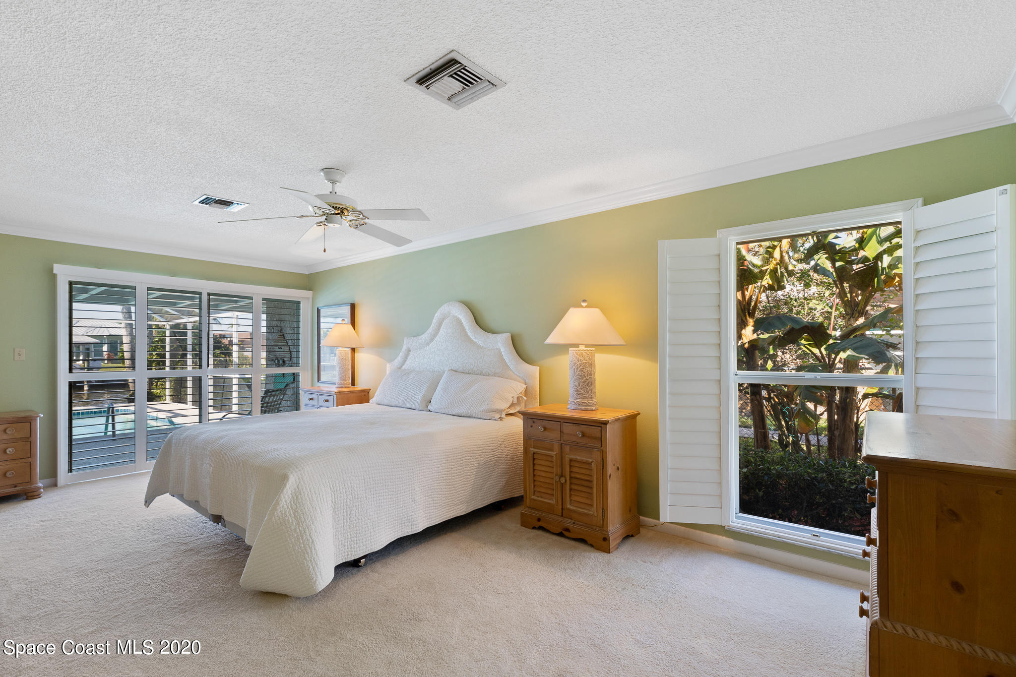 43 Country Club Road Cocoa Beach, FL 32931 - Photo 20 of 35 a bedroom with a bed and a large window