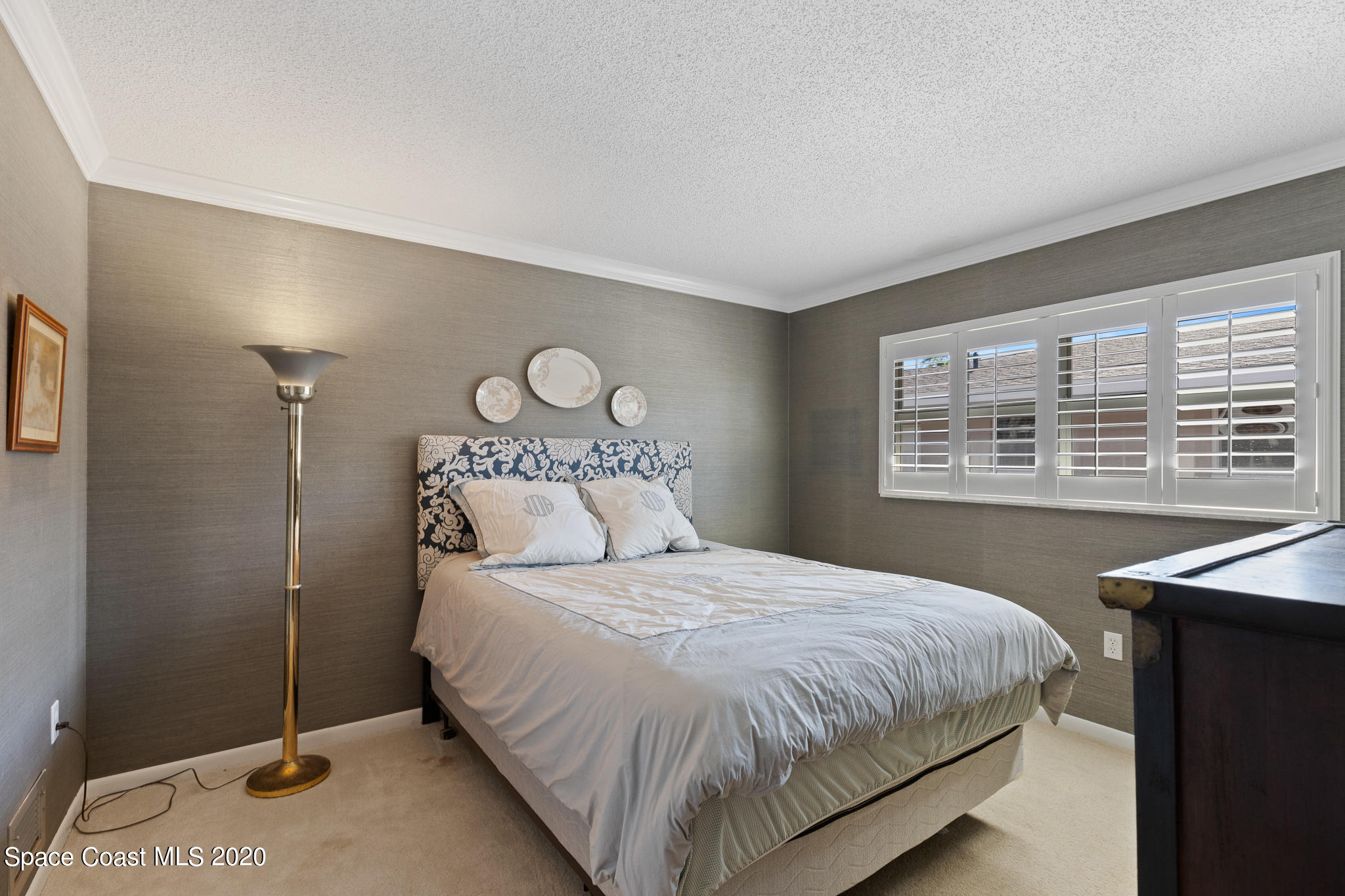 43 Country Club Road Cocoa Beach, FL 32931 - Photo 22 of 35 a bedroom with a bed and a window