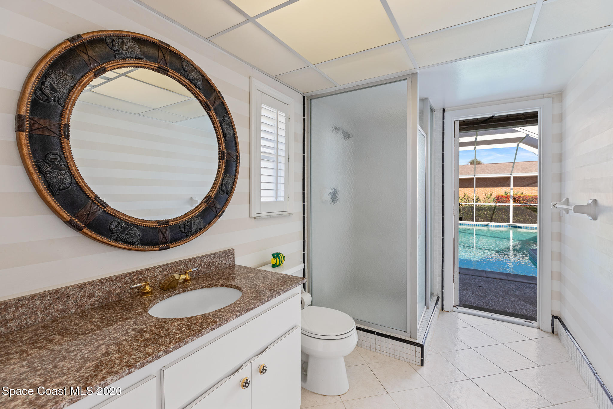 43 Country Club Road Cocoa Beach, FL 32931 - Photo 23 of 35 a bathroom with a granite countertop sink and a mirror