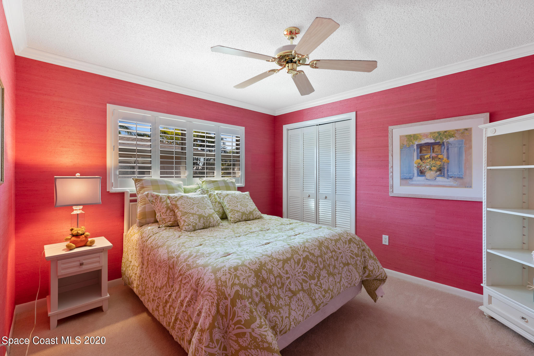43 Country Club Road Cocoa Beach, FL 32931 - Photo 24 of 35 a bedroom with a bed and a chandelier