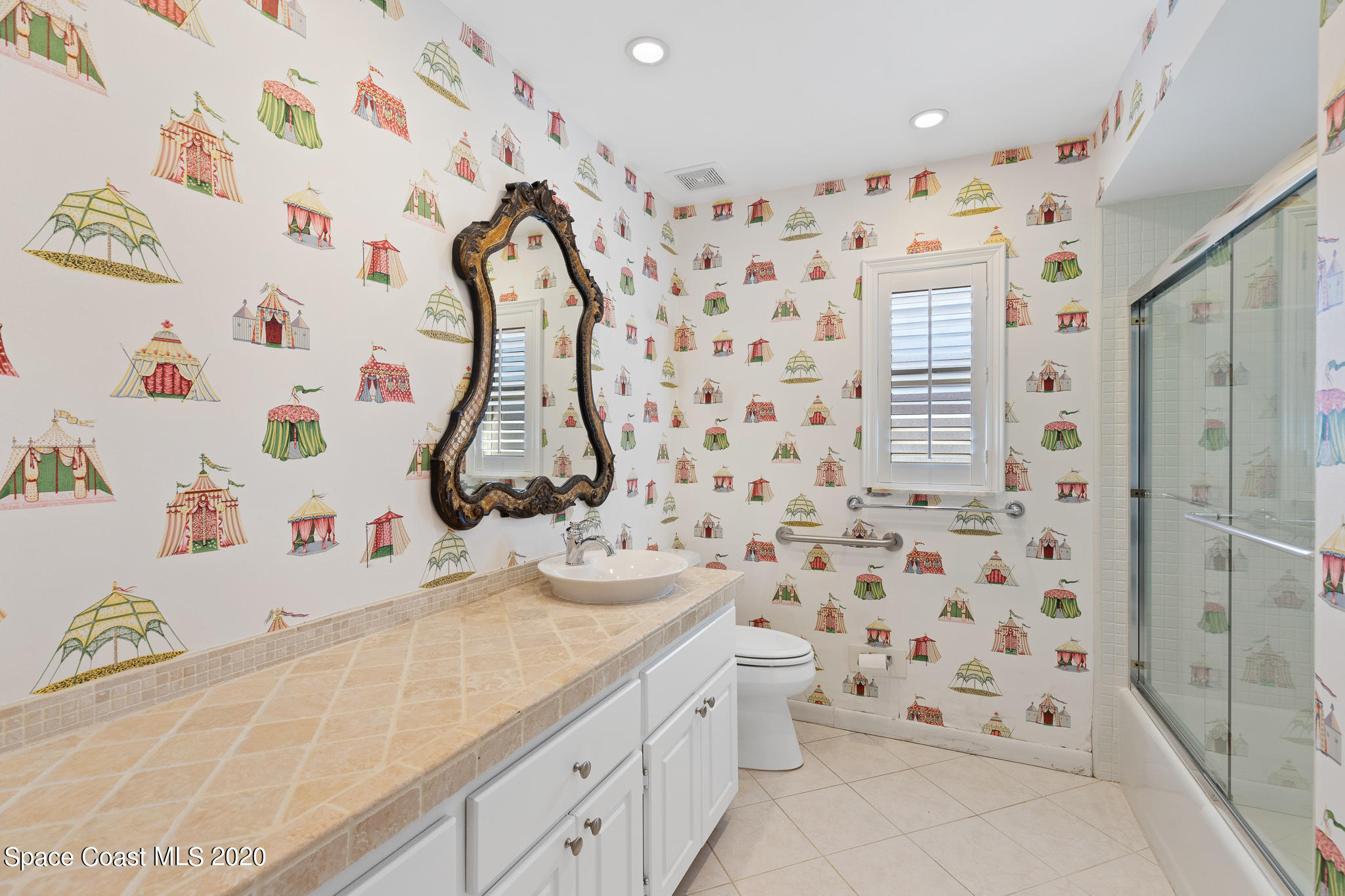 43 Country Club Road Cocoa Beach, FL 32931 - Photo 25 of 35 a bathroom with a sink and a shower curtain