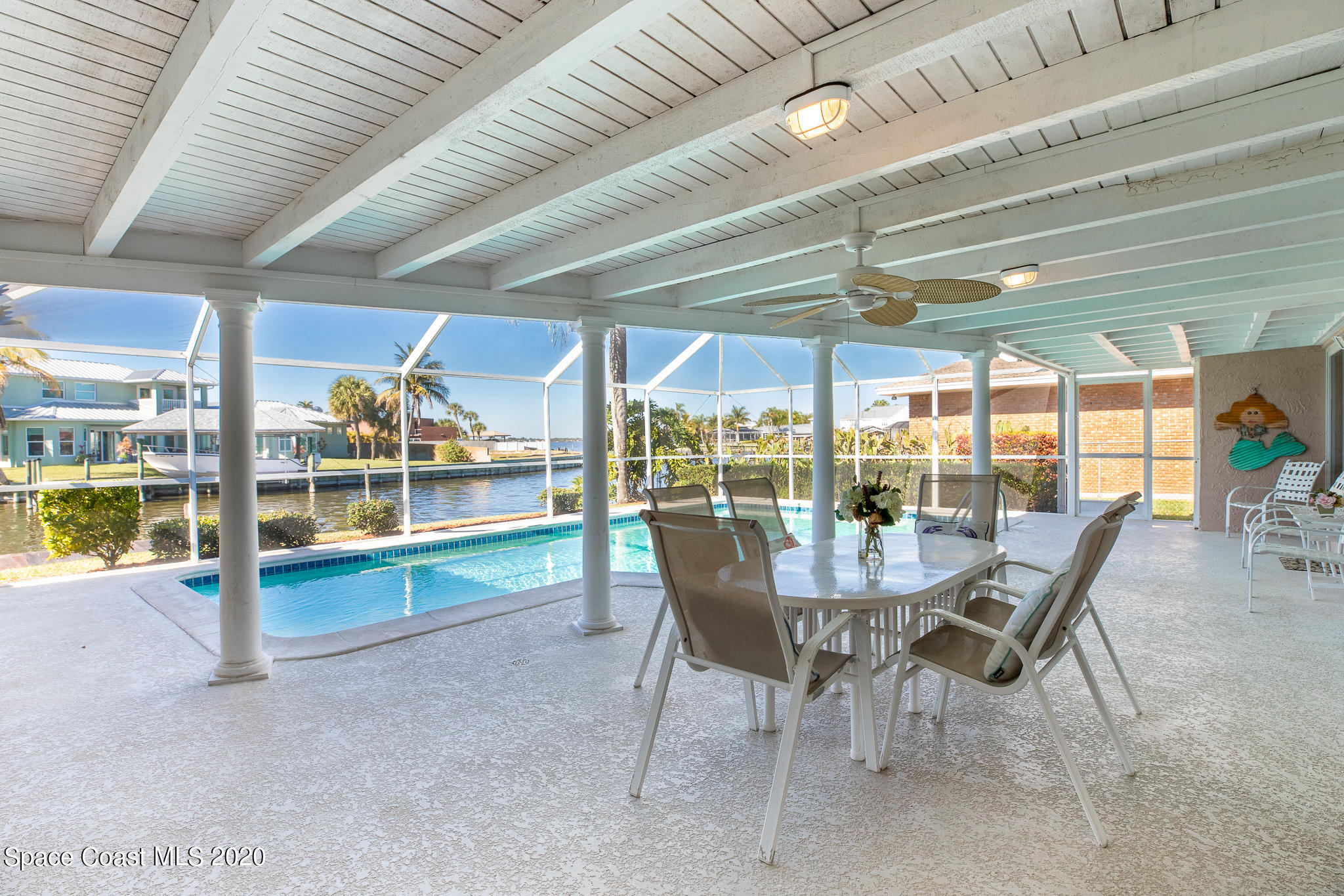 43 Country Club Road Cocoa Beach, FL 32931 - Photo 28 of 35 a dining room with furniture and floor to ceiling window