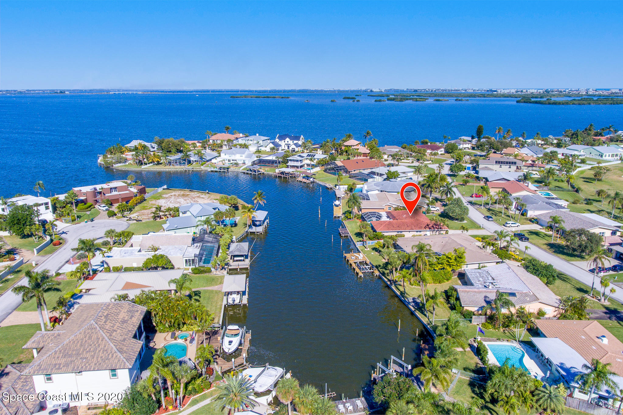43 Country Club Road Cocoa Beach, FL 32931 - Photo 8 of 35 a view of a lake with a building in the background
