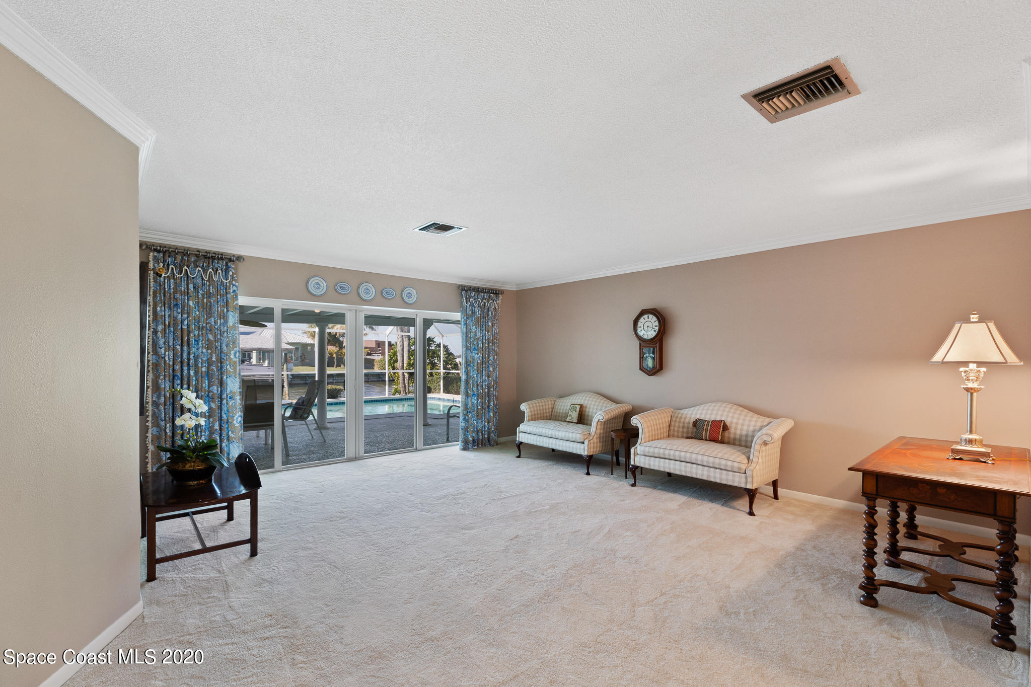 43 Country Club Road Cocoa Beach, FL 32931 - Photo 10 of 35 a living room with furniture and a lamp