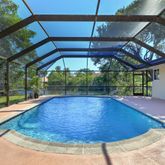 a view of a backyard with a swimming pool