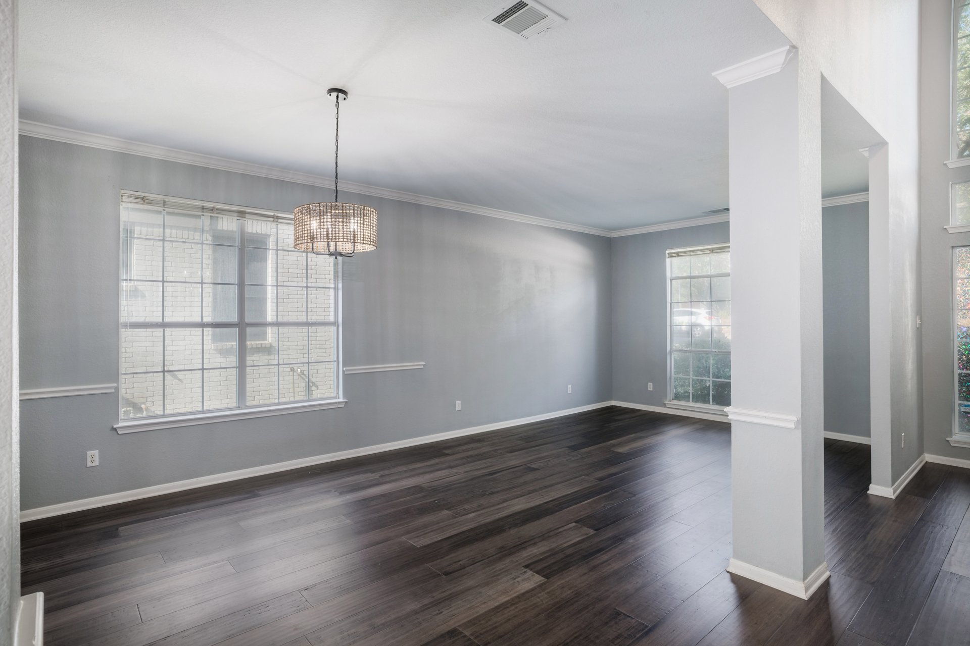 7113 Bending Oak Road Austin, TX 78749 - Photo 12 of 39 Rich dark wood flooring and elegant crown molding define this versatile dining area.
