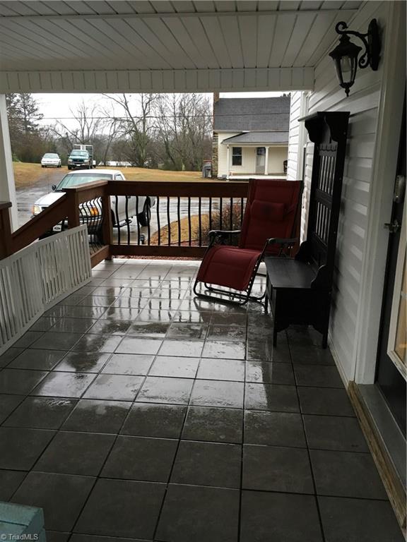 Covered side porch with ceramic tile flooring