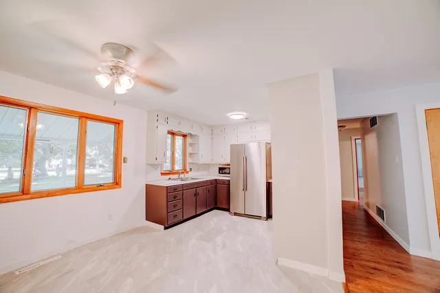 a living room with stainless steel appliances kitchen island furniture and a chandelier