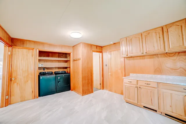 a bedroom with a bed and cabinets
