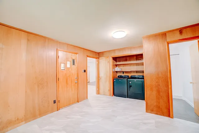 a view of a kitchen with refrigerator and wooden floor